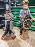 Both captain figurines side by side on table