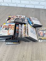 Stacked DVDs showing variety of titles and case conditions