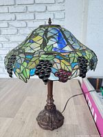 Full view of stained glass grapevine table lamp showing shade and base