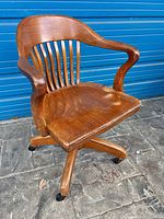 Front angled view showing entire chair, arms, seat, casters