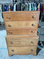 Front view showing all five drawers and knobs