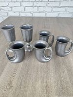 All six pewter pieces grouped together