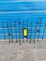Full view of black iron wall rack against blue wall