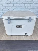 Front view showing Yeti badge and damaged latches