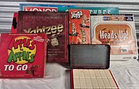 Front view of all boxed games with domino case displayed