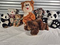 Group shot of eight assorted plush toys