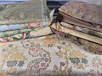 Stacked fabric remnants showing variety of colors, weaves and sizes