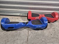 Blue Hover-1 and red Rydon hoverboards on floor