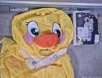 Yellow chick costume head and astronaut package sleeve visible
