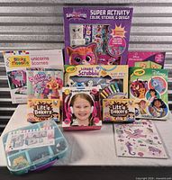Group shot of all boxed craft kits, coloring books, card games, bead organizer and sticker sheet