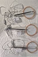 Three LED grow lights showing LED panels, stakes, cords and adapters
