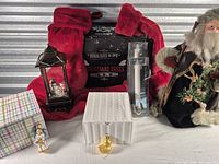 Group shot of all items: stockings, sign, lantern snow globe, candles, Santa, ornaments