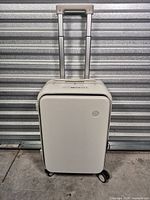 Front view of Mixi white carry-on suitcase with telescopic handle extended