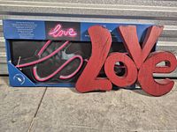 Both signs side by side, LED sign in box, metal sign visible
