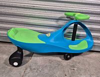 Full side view of blue and green PlasmaCar