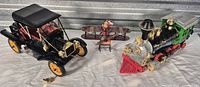 Full view of the three metal toys on table