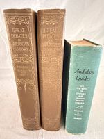 Spine view of three hardcover books: Audubon guide (green) and two Great Debates volumes (brown)