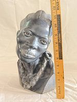 Front view of bust with ruler showing height