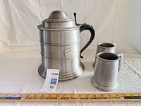 Full view of pewter ice bucket stein with two tankards and ruler for scale