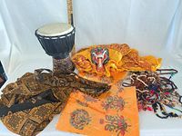 Group shot showing drum, textiles, mask, bead necklaces