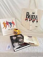 Group shot of tote, mug, hardcover book, booklet
