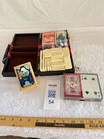 Overall lot showing open case, tiles, three card decks, dice area
