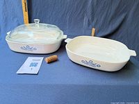 Both baking dishes, one with lid, ruler and cork for scale