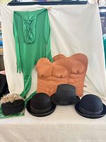 full lot view showing morph suit, two muscle torsos, four hats