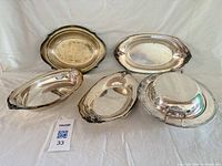 All five silver plated serving pieces overview