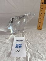 Full side view of clear crystal polar bear with ruler indicating size