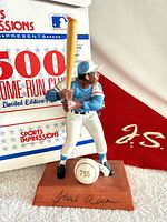 Figurine in front of box and pennant showing overall appearance and baseball marked 755