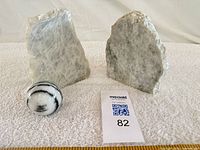 Front view of both quartz bookends flanking polished sphere, ruler for scale