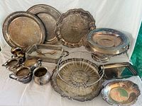 Group shot showing all silver-plated trays, bowls, rack, fruit basket, small pitchers