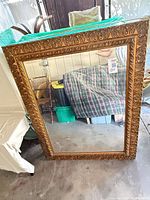 Front view of large ornate gold framed mirror