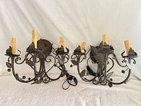 Both wrought iron wall sconces front view showing overall design and wiring