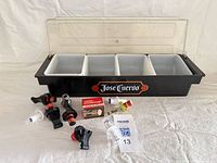 Garnish server open with inserts, assorted pour spouts, boxed stopper