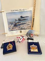 Group shot showing Blue Angels print, ornaments in boxes, plush elephant, eagle figurine