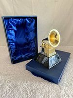 Statuette with presentation box open showing blue satin lining