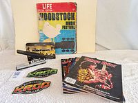 Front view showing LIFE Woodstock magazine, PickPunch box, metal punch, Vintage Guitar stack and KROQ stickers