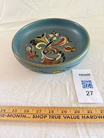 Top view showing interior Rosemaling design and ruler for scale