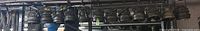 Row of twelve black PAR 56 cans hanging on bar