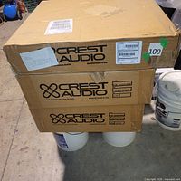 Three Crest Audio cartons stacked, showing branding and quantity