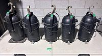 Front and side view of five black PAR 64 cans standing upright with clamps attached