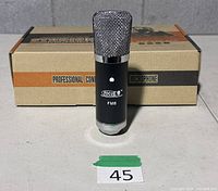 Microphone standing in front of retail box