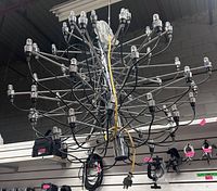overall view of chrome multi-arm chandelier hanging, showing sockets and wiring