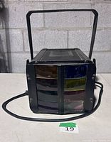 Front view showing coloured lens panels and power cord