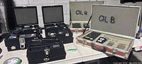 Overview of multiple open road cases showing wireless microphone systems on table
