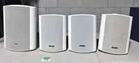 Front view of four white Tortech EMS series speakers