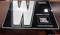 Front of large JBL W Series plexiglass sign showing graphics and overall condition
