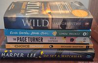 Stack of all five books showing spines and titles